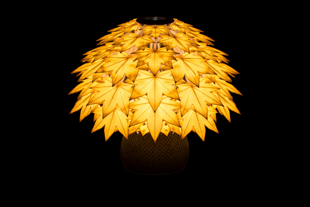 Decorative lamp with Maple leaf-like design on a black background
