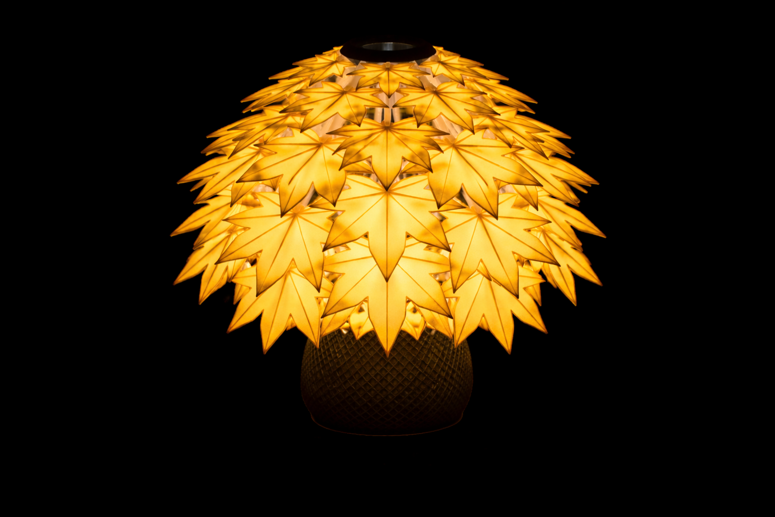 Decorative lamp with Maple leaf-like design on a black background